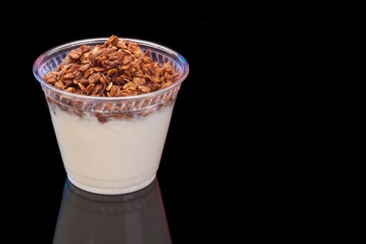 Yogurt with chocolade granola on black background with copyspace