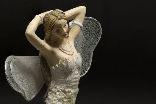 single blond fairy with black background