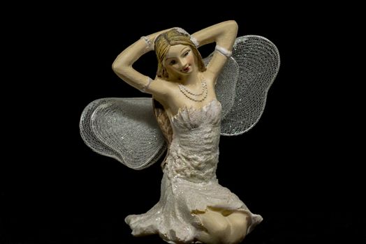 single blond fairy with black background