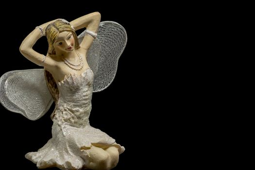 single blond fairy with black background