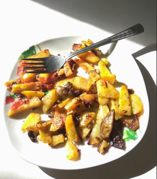 Fried potatoes with mushrooms on a plate