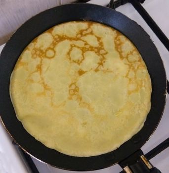 Russian blini pancakes on a plate Gzhel. Maslenitsa is an Eastern Slavic traditional holiday. Gzhel-Russian folk craft of ceramics and production porcelain and a kind of Russian folk painting.