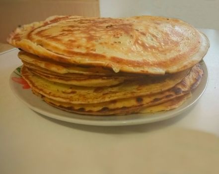 Russian blini pancakes on a plate Gzhel. Maslenitsa is an Eastern Slavic traditional holiday. Gzhel-Russian folk craft of ceramics and production porcelain and a kind of Russian folk painting.