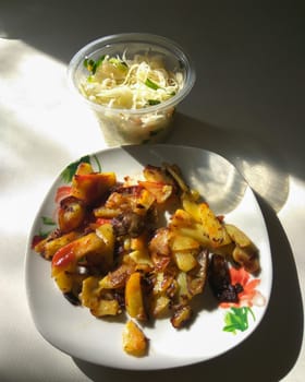 Fried potatoes with mushrooms on a plate