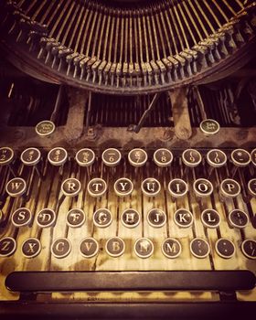 Keys of an old rusty and dusty typewriter. Retro style photo.