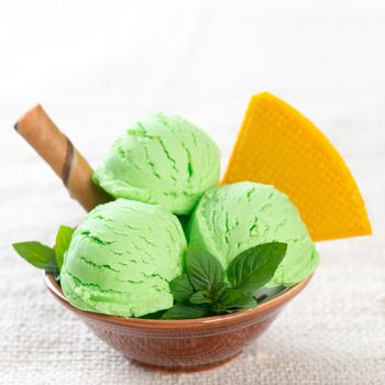 Bowl of green yogurt ice cream on dining table.
