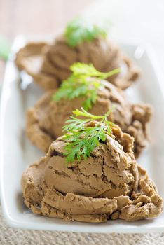Plate of chocolate ice cream on dining table background.