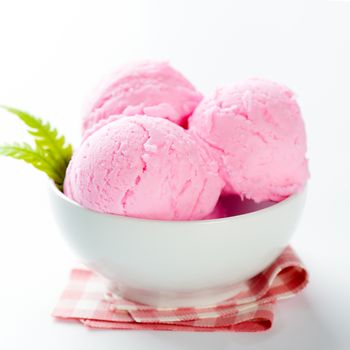Pink ice cream in bowl on white background.