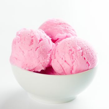 Strawberry ice cream in bowl on white background.