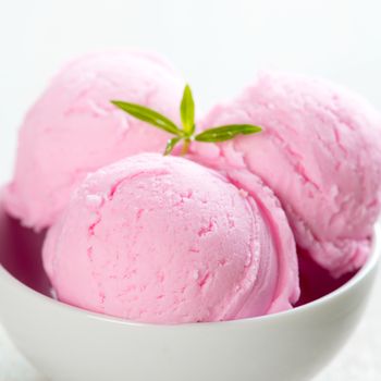 Strawberry ice cream in bowl close up.