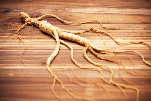 Dry ginseng on a wood background