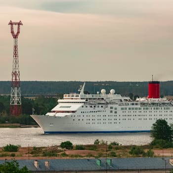 White passenger ship. Cruize ferry sailing past old town