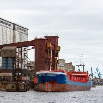 Blue cargo ship loading in the port of Riga, Europe