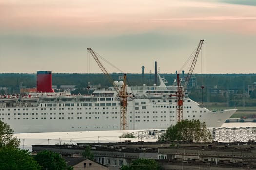White passenger ship. Cruize ferry sailing past old town