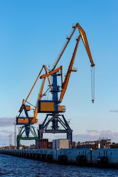 Yellow cargo cranes in the port of Riga, Europe