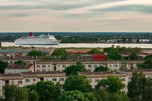 White passenger ship. Cruize ferry sailing past old town
