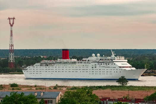White passenger ship. Cruize ferry sailing past old town