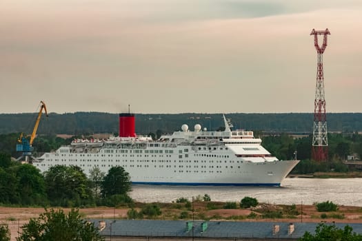 White passenger ship. Cruize ferry sailing past old town