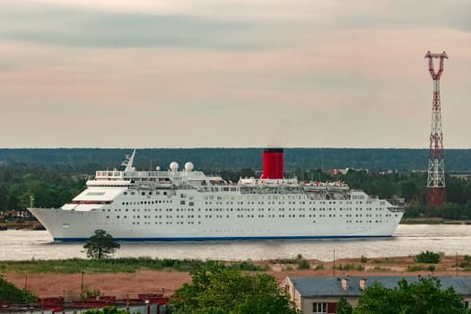 White passenger ship. Cruize ferry sailing past old town