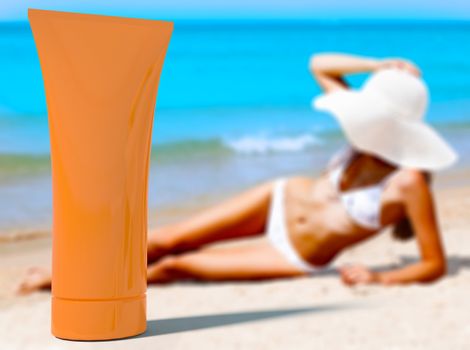 Woman in a swimsuit against the background of the blue sea and orange bottle of sunblock cream or lotion