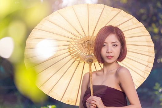 Portrait of asian woman wearing traditional thai holding of yellow umbrella, 
beautiful thai woman in thai costume, beautiful asian woman