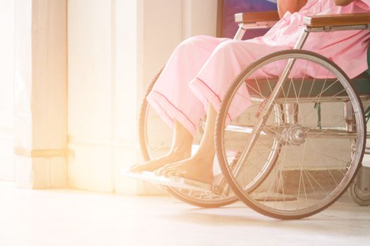 Abstract Of Woman On Wheelchair In Front Of The Outpatient Department Of Hospital With Softlight.