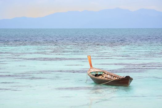 The Wooden Boat On Clear Blue Sea.