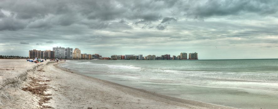 Buildings in the distance on Marco Island, Florida, beach under an overcast sky in winter