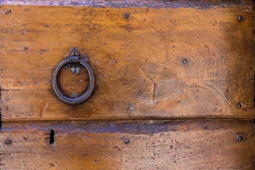 Close up of rustic old door in Spoleto, Italy.