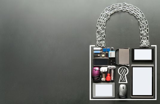 Various devices including tablets, computer mouse, usb cards in the shape of a padlock on a chalkboard background