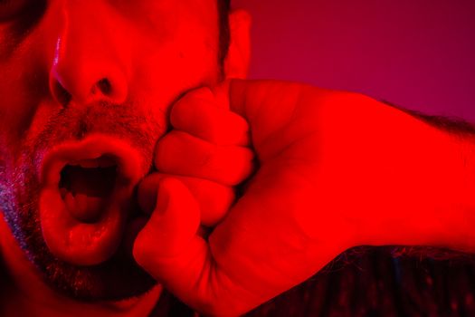 Closeup of man getting punched in the jaw. Hand of a man hitting other man in the face. 