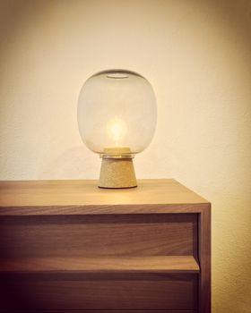 Retro style glass lamp on a wooden dresser. Cozy home decor.