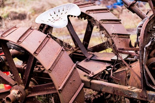 Rusty steel tractor wheels and seat cropped