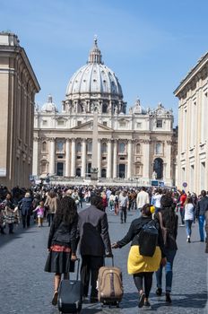 ROME - MARCH 30: people walking toward the St. Peter's church during the sunday Angelus on March 30, 2014 in Rome