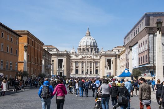 ROME - MARCH 30: people walking toward the St. Peter's church during the sunday Angelus on March 30, 2014 in Rome