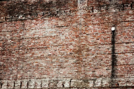 Old eroded stained brick wall background