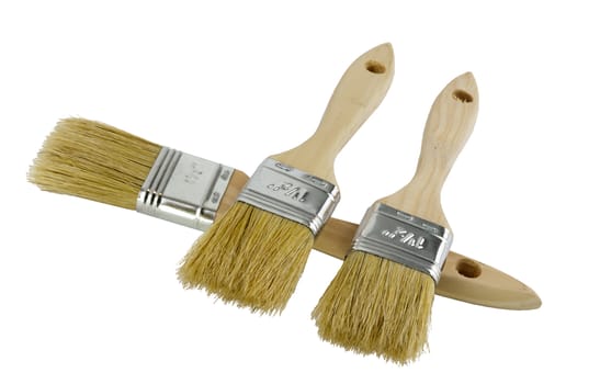 Wooden handled paint brushes lying on the side