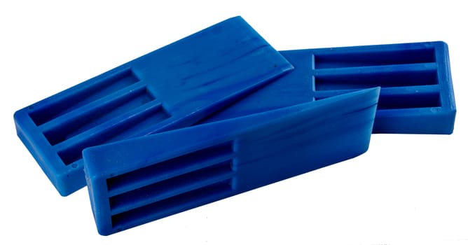 Blue plastic molding wedges stacked on side view