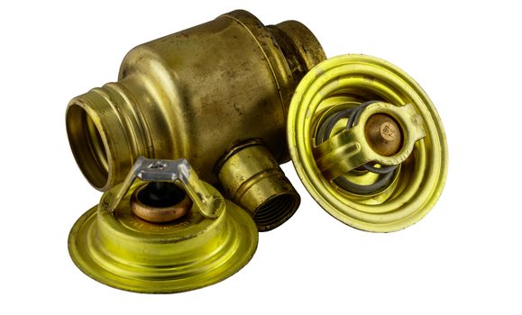 Antique vintage american automobile brass thermostat assemblies on a white background.