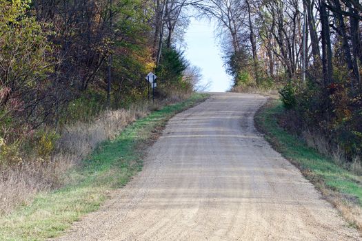 A gravel road snakes up the hill runing out of the valley.
