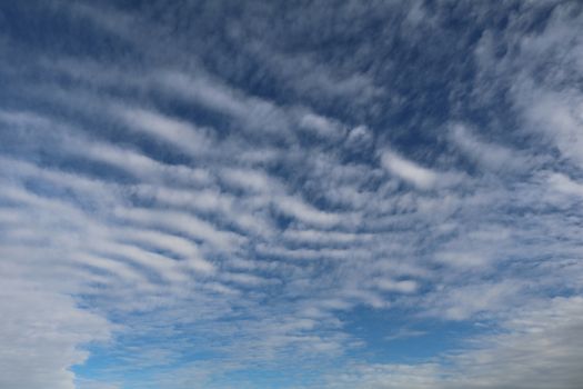Altocumulous clouds show against the blue sky.