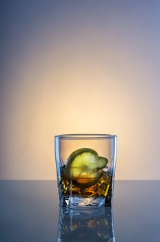 Aalcohol cocktail with yellow lemon on glass table