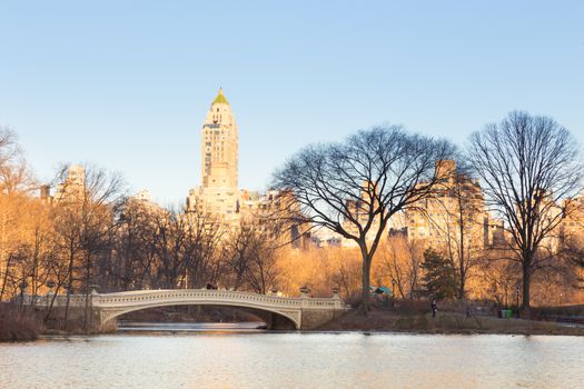 New York City Manhattan Central Park panorama of The lake with Bow bridge, skyscrapers and colorful trees in autumn.