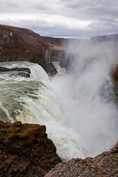 Powerful Gullfoss waterfall and its canyon in a cloudy day, Iceland