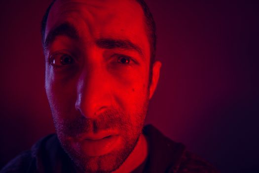 Man raises an eyebrow with shocked facial expression. Close up headshot portrait of shocked man.
