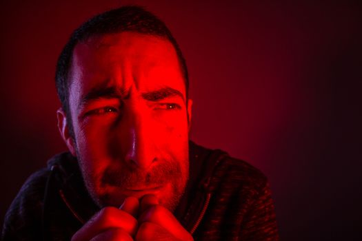 Man with terrified facial expression. Close up headshot portrait of crying man with his hand on the face.