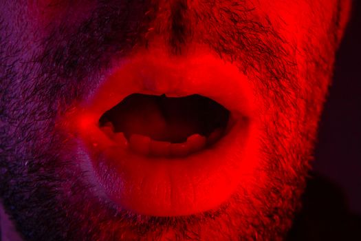 Macro closeup on man with surprised facial expression with opened mouth. Headshot portrait of shocked man.