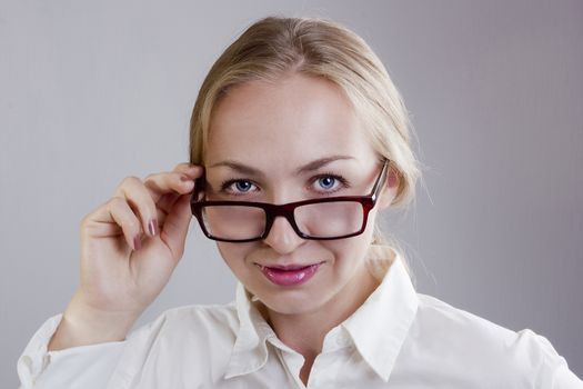 Portrait of a young beautiful blonde woman with glasses