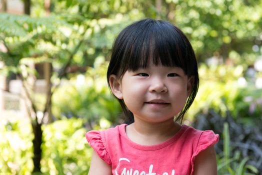 Portrait of beautiful asian child girl in outdoor park
