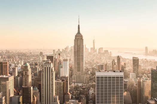 New York City. Manhattan downtown skyline with illuminated Empire State Building and skyscrapers at sunset. USA.